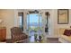 Balcony view showcasing waterfront scenery, featuring a comfortable chair and table setting at 7342 Captain Kidd Ave, Sarasota, FL 34231