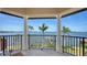 Waterfront views seen from the covered balcony area with classical columns and iron railings at 7342 Captain Kidd Ave, Sarasota, FL 34231