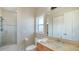 Bathroom with walk-in shower, vanity, light colored walls, and light tile flooring at 7342 Captain Kidd Ave, Sarasota, FL 34231