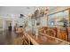 Dining room features a decorative chandelier, hardwood floors, and an adjacent living room at 7342 Captain Kidd Ave, Sarasota, FL 34231
