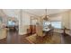 Dining room with hardwood floors, decorative chandelier, and water views at 7342 Captain Kidd Ave, Sarasota, FL 34231