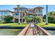 A multi-story home overlooking waterfront, with a private dock, pool and manicured lawn at 7342 Captain Kidd Ave, Sarasota, FL 34231