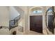 Inviting foyer featuring a striking wooden double door entrance and a staircase with elegant iron railings at 7342 Captain Kidd Ave, Sarasota, FL 34231