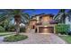 Stately two-story home featuring an attached two-car garage and beautiful palm tree landscaping at 7342 Captain Kidd Ave, Sarasota, FL 34231