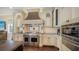 The kitchen features a professional-grade stainless steel range, custom hood, and beautiful tile backsplash at 7342 Captain Kidd Ave, Sarasota, FL 34231