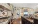 Gourmet kitchen features high-end appliances, custom cabinetry, and a large center island with copper prep sink at 7342 Captain Kidd Ave, Sarasota, FL 34231