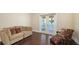 Comfortable living room featuring a sectional sofa, armchair, and access to an outdoor balcony with water views at 7342 Captain Kidd Ave, Sarasota, FL 34231