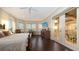 Water view Primary bedroom with balcony access, wood floors, and gorgeous sunset views at 7342 Captain Kidd Ave, Sarasota, FL 34231