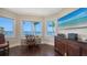 Home office with water views features custom cabinets, a desk, and a comfortable reading nook at 7342 Captain Kidd Ave, Sarasota, FL 34231