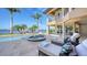 A covered patio shows lounge furniture beside a pool and scenic water views at 7342 Captain Kidd Ave, Sarasota, FL 34231