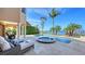 An in-ground pool and hot tub enhance the outdoor leisure space, overlooking beautiful waters at 7342 Captain Kidd Ave, Sarasota, FL 34231