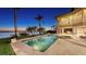 Luxury home with a serene pool, spa, and waterfront views, complemented by a landscaped backyard and patio area at 7342 Captain Kidd Ave, Sarasota, FL 34231