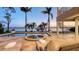 An outdoor pool and spa area with dock access to the waterway, featuring luxurious lounge seating at 7342 Captain Kidd Ave, Sarasota, FL 34231