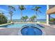 Backyard pool with a spa and dock access showcasing waterfront living and stunning views at 7342 Captain Kidd Ave, Sarasota, FL 34231