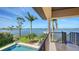 Back porch view featuring the pool, lush landscaping, and the tranquil waterfront at 7342 Captain Kidd Ave, Sarasota, FL 34231