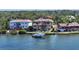 Waterfront home with a private dock, boat lift, manicured lawn and mature landscaping at 7342 Captain Kidd Ave, Sarasota, FL 34231