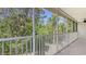 Screened balcony with view of lush green trees, offering privacy and tranquility at 7632 Marsh Orchid Cir # 7632, Bradenton, FL 34203
