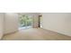 Bedroom with doors to the balcony offering a view and natural light at 7632 Marsh Orchid Cir # 7632, Bradenton, FL 34203