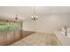 Dining area features hardwood floors, chandelier, and sliding door to the balcony at 7632 Marsh Orchid Cir # 7632, Bradenton, FL 34203