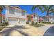 Charming two-story building with a paved driveway, two-car garage, and well-maintained landscaping at 7632 Marsh Orchid Cir # 7632, Bradenton, FL 34203