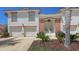 Inviting two-story building showcasing a well-manicured lawn, covered entry, and two-car garage at 7632 Marsh Orchid Cir # 7632, Bradenton, FL 34203