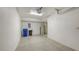 Spacious garage featuring a textured floor, offering ample space for storage, with bright overhead lighting at 7632 Marsh Orchid Cir # 7632, Bradenton, FL 34203
