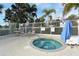 Relaxing hot tub with lounge chairs and lush landscaping, perfect for enjoying the outdoors at 7632 Marsh Orchid Cir # 7632, Bradenton, FL 34203