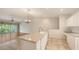 Bright, open kitchen featuring an island, tiled floors, and a seamless transition to the living area at 7632 Marsh Orchid Cir # 7632, Bradenton, FL 34203