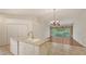 Bright, open kitchen featuring an island, tiled floors, and a seamless transition to the living area at 7632 Marsh Orchid Cir # 7632, Bradenton, FL 34203