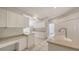 Spacious kitchen offers ample cabinet space, neutral countertops, and tile flooring at 7632 Marsh Orchid Cir # 7632, Bradenton, FL 34203