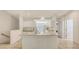 Bright, open kitchen featuring an island, tiled floors, and white cabinets at 7632 Marsh Orchid Cir # 7632, Bradenton, FL 34203