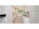 Open kitchen design with white cabinetry, stainless appliances, and view of the dining area at 7632 Marsh Orchid Cir # 7632, Bradenton, FL 34203
