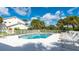 Sparkling community pool and sundeck with plenty of lounge chairs, palm trees, and serene views at 7632 Marsh Orchid Cir # 7632, Bradenton, FL 34203