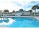 Community pool offers a refreshing way to relax, with a view of the clubhouse and blue skies above at 7632 Marsh Orchid Cir # 7632, Bradenton, FL 34203