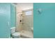 Updated shower featuring a tiled surround, shower seat and handheld shower fixture at 7632 Marsh Orchid Cir # 7632, Bradenton, FL 34203