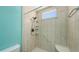 Close up of updated shower featuring a tiled surround, shower seat and handheld shower fixture at 7632 Marsh Orchid Cir # 7632, Bradenton, FL 34203