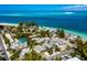 Breathtaking aerial view of beach house community with white sand beaches and stunning ocean views at 811 Jacaranda Rd, Anna Maria, FL 34216