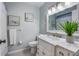 Bright bathroom features a white vanity, ample counter space, and coastal decorations at 811 Jacaranda Rd, Anna Maria, FL 34216