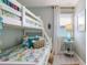 Coastal-themed bedroom with a bunk bed, light blue walls, and beachy accents at 811 Jacaranda Rd, Anna Maria, FL 34216