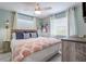 Comfortable bedroom features light walls, a wooden bed frame, and ample natural light from the windows at 811 Jacaranda Rd, Anna Maria, FL 34216