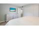 Bright bedroom with a white dresser, a flat screen tv, and a comfortable queen bed at 811 Jacaranda Rd, Anna Maria, FL 34216