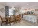 Bright dining area showcases a wooden table, chandelier, and an adjacent kitchen with white cabinets and a butcher block counter at 811 Jacaranda Rd, Anna Maria, FL 34216