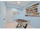 A bright and inviting game room, complete with foosball table and coastal-themed decor at 811 Jacaranda Rd, Anna Maria, FL 34216