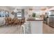 Modern kitchen with a breakfast bar, stainless steel appliances, and a dining area at 811 Jacaranda Rd, Anna Maria, FL 34216
