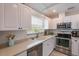 Bright kitchen with stainless steel appliances and abundant cabinet space at 811 Jacaranda Rd, Anna Maria, FL 34216