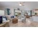 Open-concept living room and dining area with stylish furnishings and abundant natural light at 811 Jacaranda Rd, Anna Maria, FL 34216