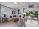 Bright and airy living room with stylish decor and sliding glass doors to a screened-in patio at 811 Jacaranda Rd, Anna Maria, FL 34216