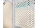 A private outdoor shower with stylish white lattice offers convenience and privacy for rinsing off after beach trips at 811 Jacaranda Rd, Anna Maria, FL 34216