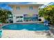 Inviting pool and patio area with colorful Anna Maria mural, perfect for outdoor relaxation at 811 Jacaranda Rd, Anna Maria, FL 34216