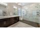 Bathroom featuring double vanity, dark wood cabinets, white countertop, glass enclosed shower and tile flooring at 8314 9Th Avenue Nw Ter, Bradenton, FL 34209